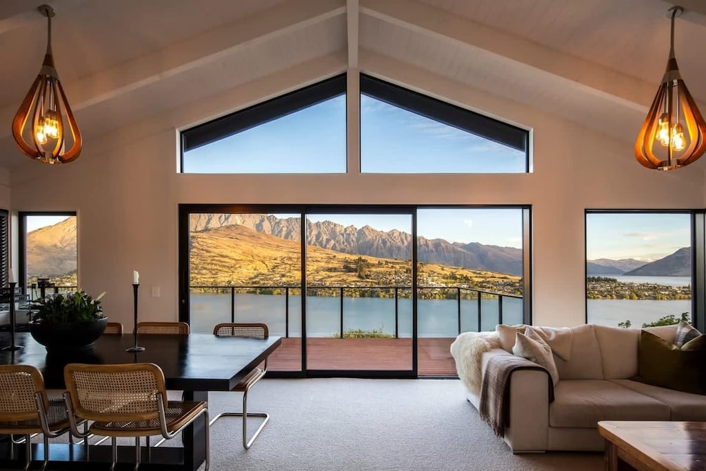 Enjoy meals with postcard-perfect views through floor-to-ceiling windows in this open-plan living and dining space.