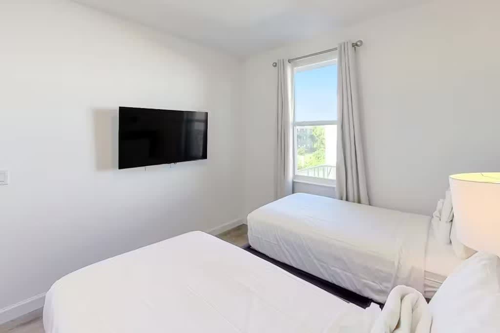 Perfect for friends or siblings, This charming bedroom offers two cozy twin beds for a restful night's sleep.