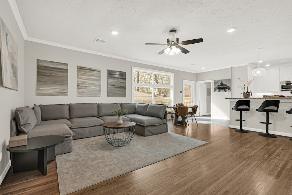 Open concept living area connecting the living room, kitchen, and breakfast space for easy group interaction.