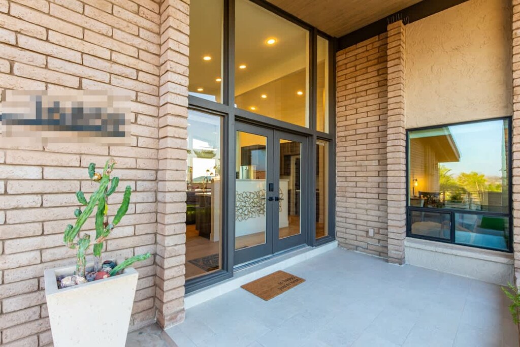 Welcome to a bright and inviting front entrance under a clear blue sky.
