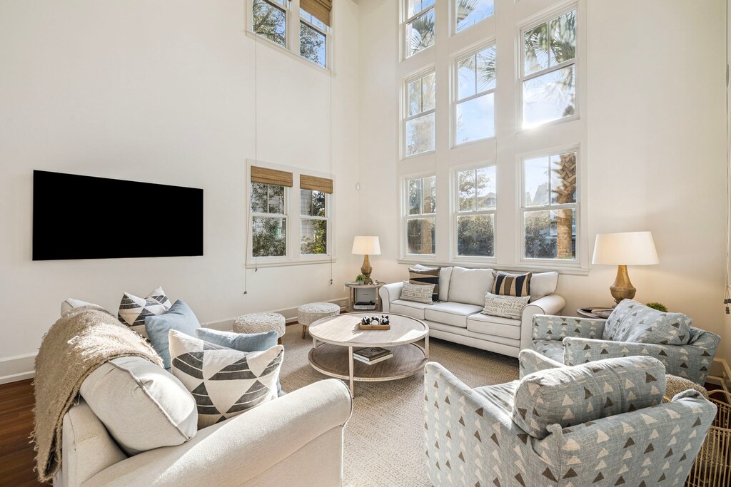 Sink into plush seating surrounded by soaring windows that flood your space with natural light and garden views.