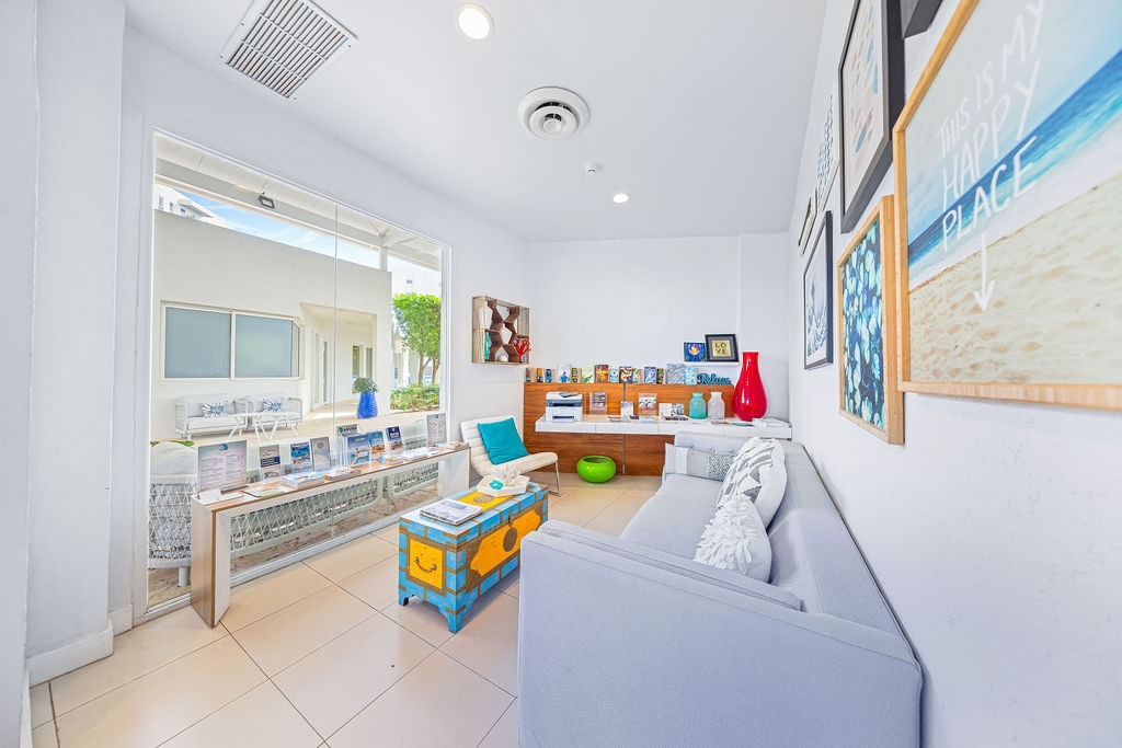 Relax in your bright, cheerful living space with comfortable seating and colorful coastal artwork adorning the walls.