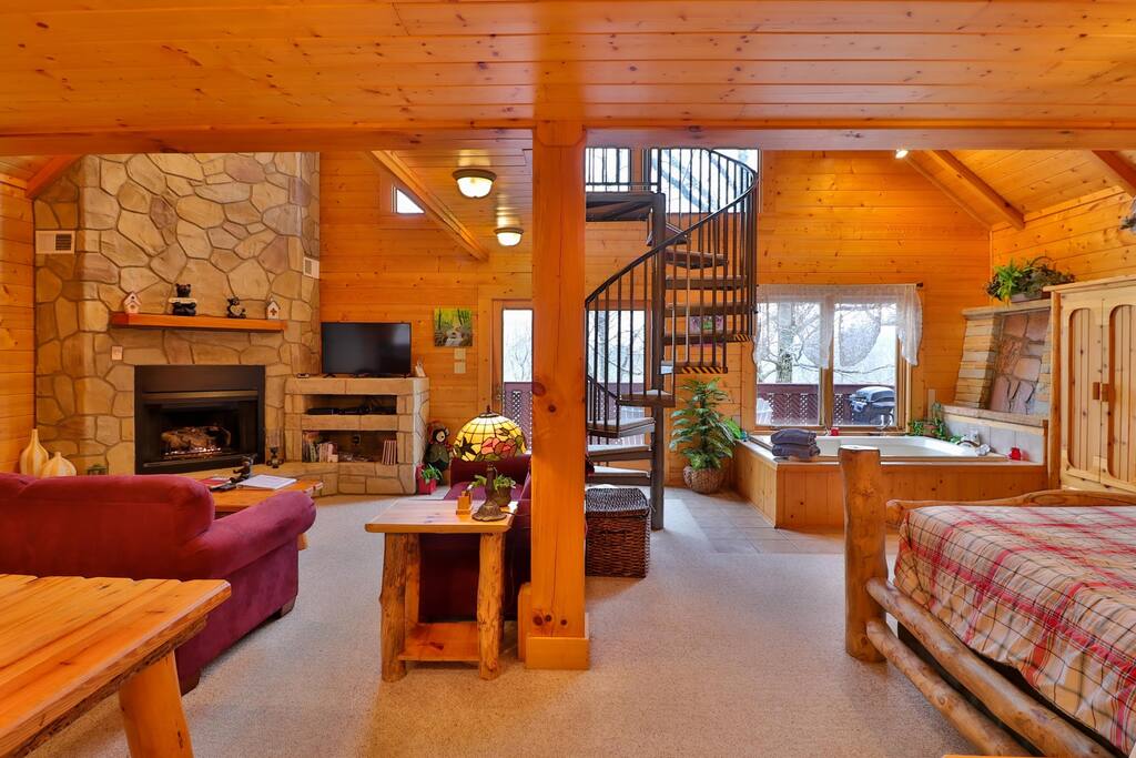 Cozy up by the stone fireplace in the inviting living room.