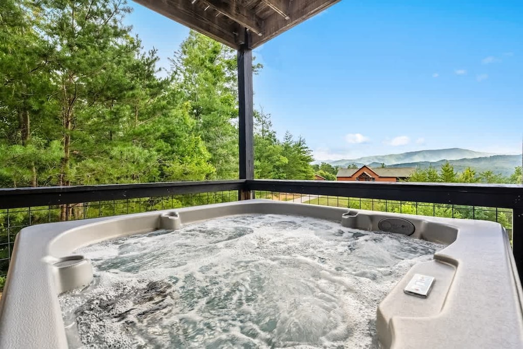 Hot Tub Retreat: Soak in tranquility while enjoying stunning mountain views and fresh air!