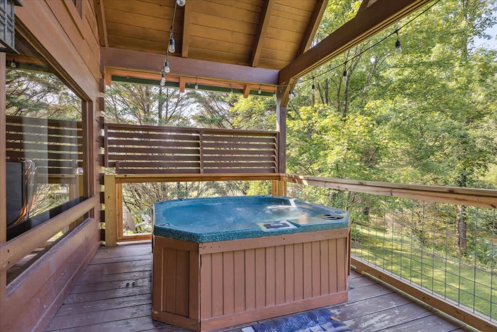 Hot Tub Retreat: Relax in the bubbling hot tub surrounded by lush green views!