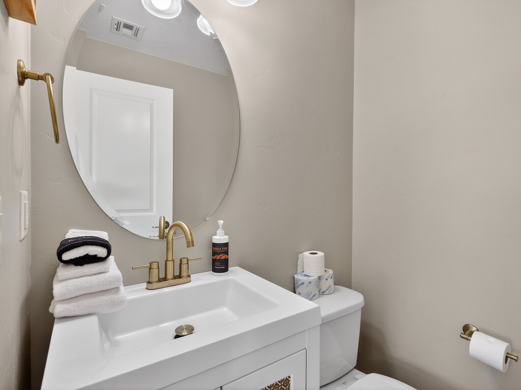 Freshen up in your stylish powder room with warm brass fixtures, fluffy towels, and thoughtful amenities.