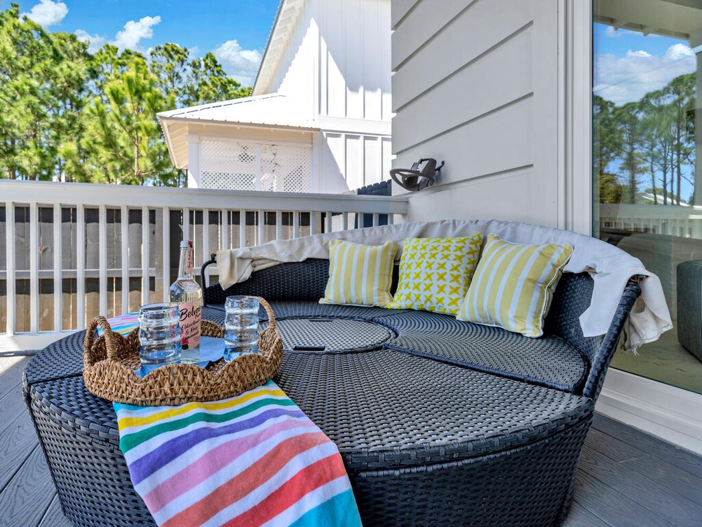 Unwind on your private balcony with plush daybeds, refreshing drinks, and colorful cushions perfect for afternoon naps.