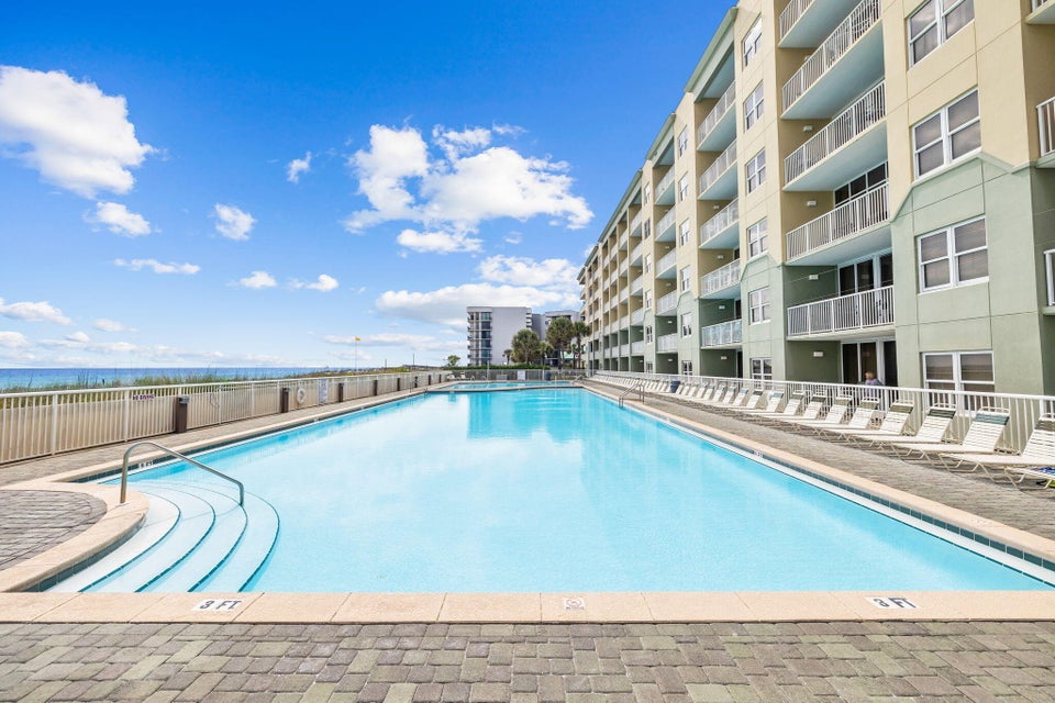 Beachfront property with sparkling pool deck and Gulf views, steps from the sand.