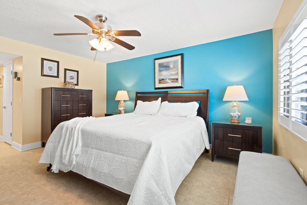 Master bedroom features a plush king bed