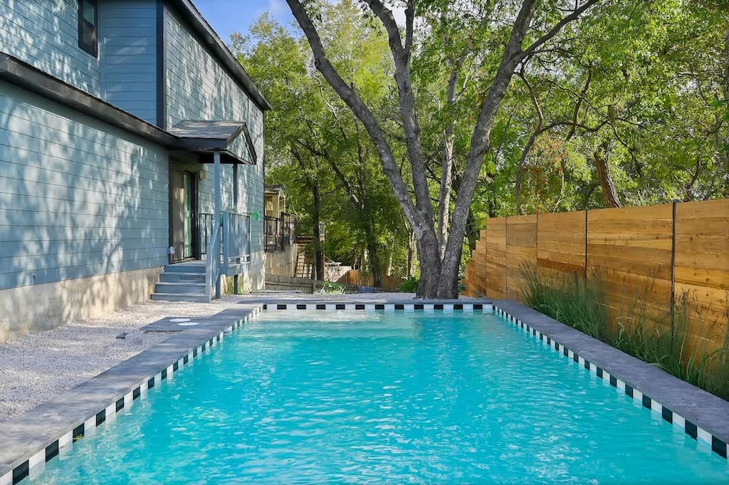 The spacious backyard oasis is accessible by both units. Take a dip in the pool or cozy up by the fire pit!