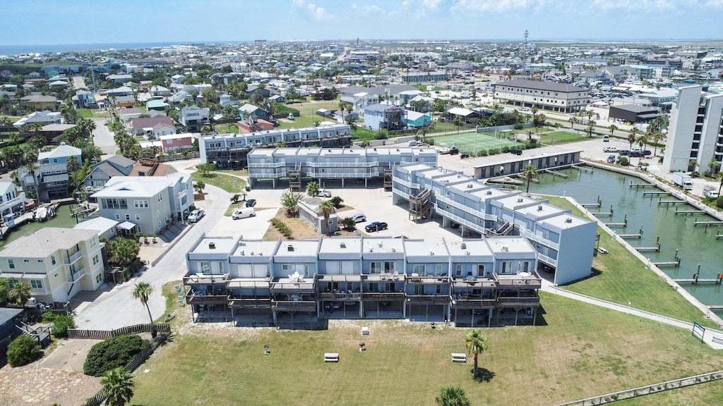 Coastal resort complex with modern architecture, waterfront access, and comprehensive amenities set within a vibrant residential community.