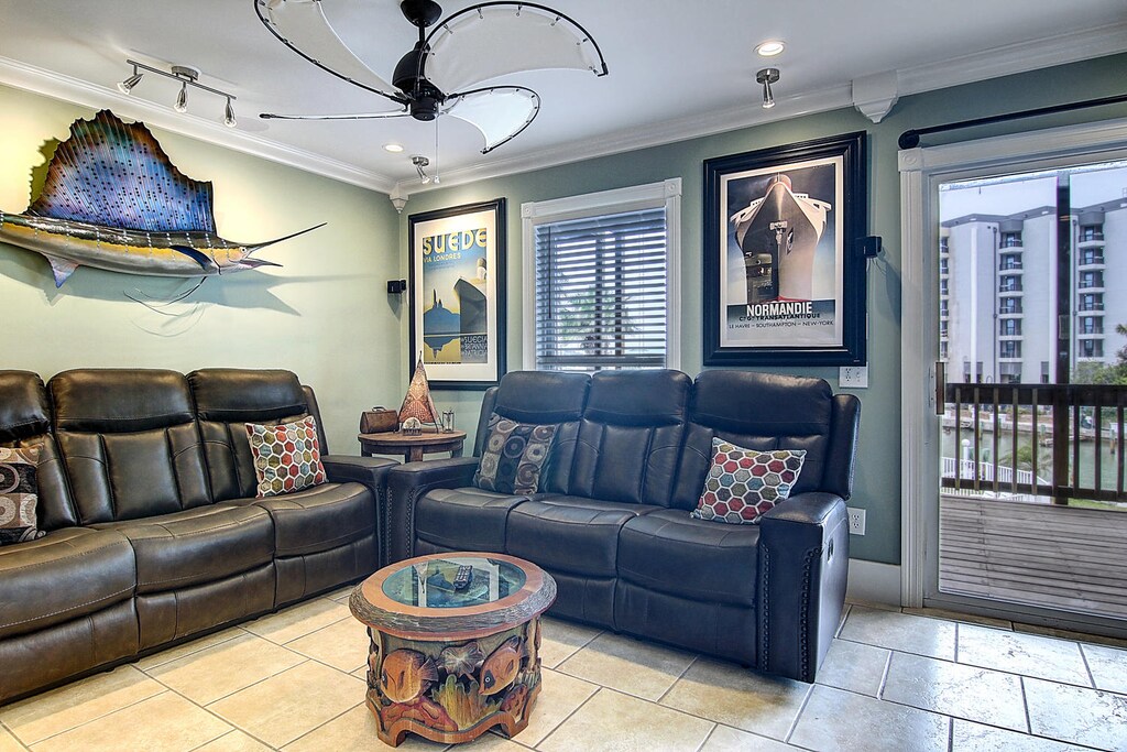 Sink into plush leather recliners in this coastal-themed living space, where nautical art and an ocean breeze create your perfect retreat.
