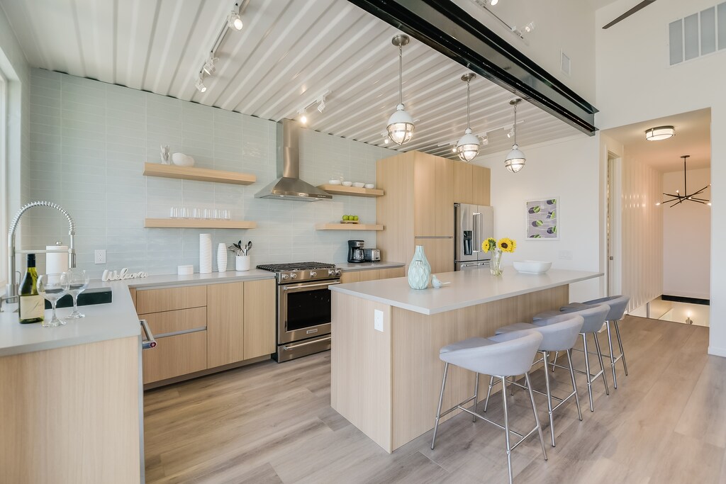 Your modern kitchen features sleek wood cabinets, quartz countertops, and a spacious island where you'll craft meals and connect with loved ones.