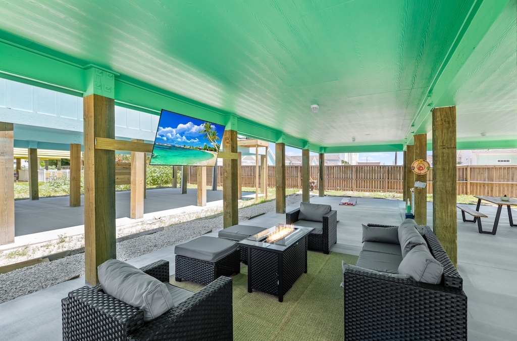 Relax under your private pavilion with plush seating and a crackling fire table while watching tropical scenes on the outdoor TV.