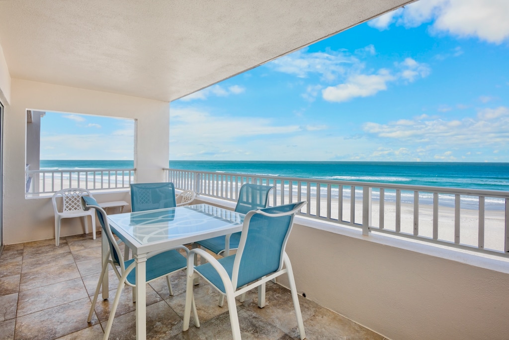 Private oceanfront balcony with dining
