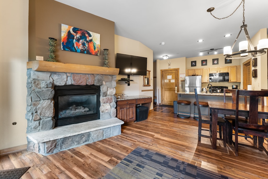 Unwind by your stone fireplace while dinner sizzles in the open kitchen, where warm wood and modern comfort create the perfect mountain retreat.