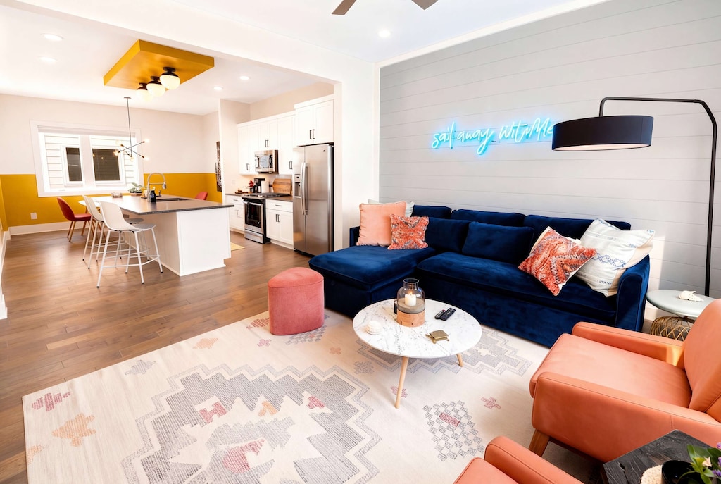 Living room flows wide open into the kitchen, so the whole group can gather in one sunlit space without anyone isolated in a separate room