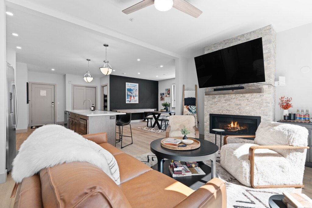 Sink into plush seating and feel the warmth of your fireplace as you unwind in this open, light-filled living space designed for total relaxation.
