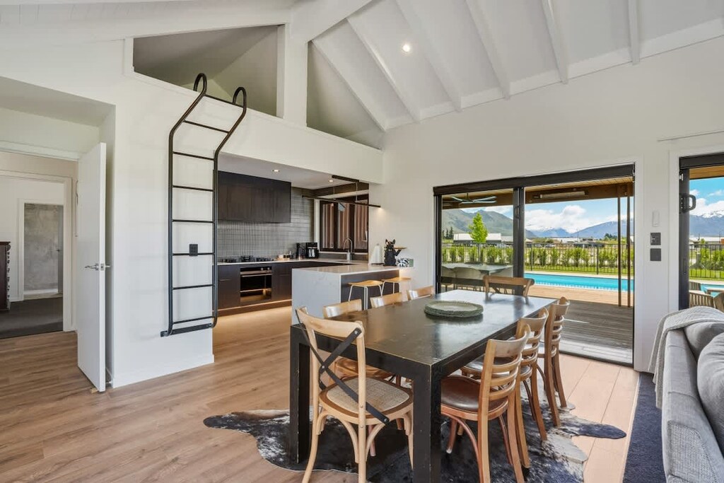Dining and kitchen with pool view