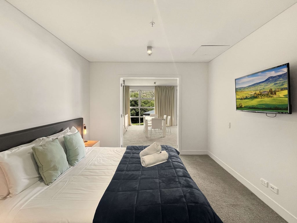 Spacious master bedroom with TV