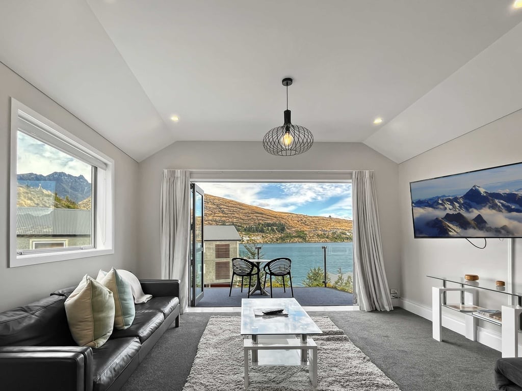Bright living with balcony and lake views