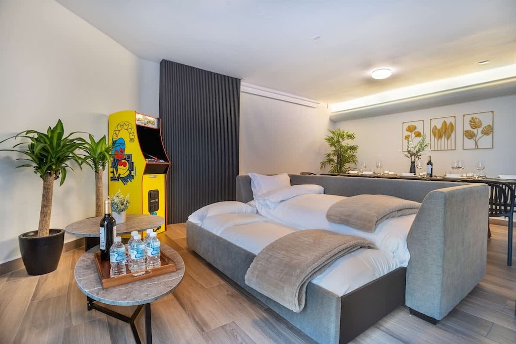 Enjoy entertainment and flexible sleeping in this living area with arcade games.