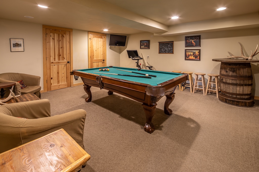 Challenge friends to pool in your private game room, complete with rustic seating and mountain lodge charm.