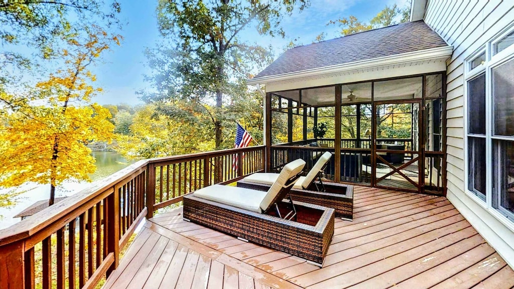 Relax in style at this stunning lakeside retreat, featuring a spacious deck with lounge chairs, a screened-in porch, and breathtaking waterfront views.