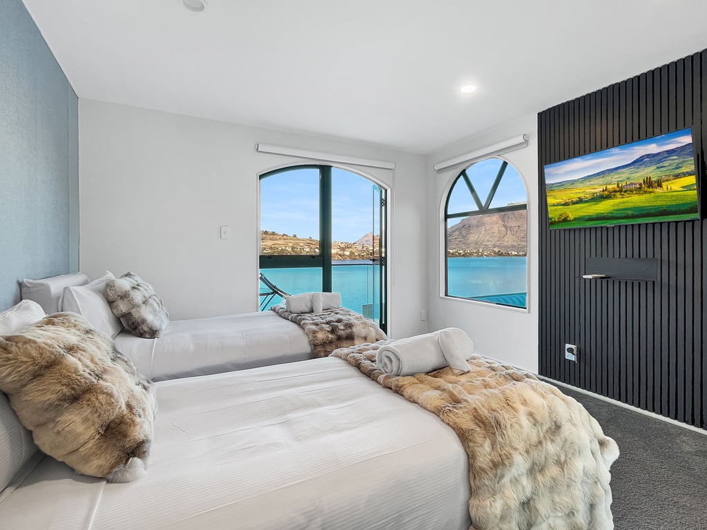 Wake up to breathtaking lake views from the spacious master bedroom with direct balcony access.
