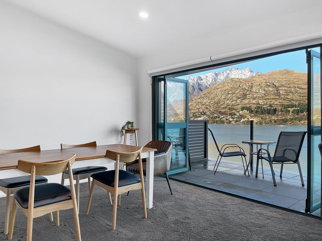 Enjoy every meal with panoramic lake views from the dining area and private balcony beyond.