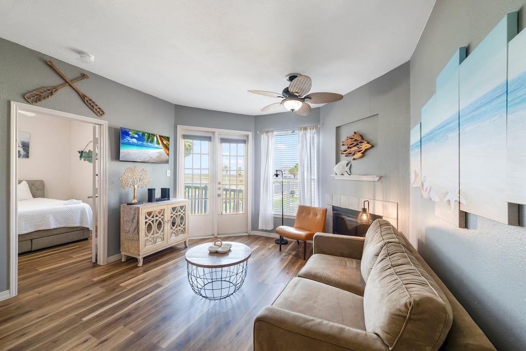 Sink into the plush sleeper sofa as coastal breezes flow through your bright living space, complete with fireplace warmth and stylish nautical touches.