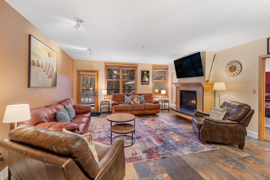 Sink into plush leather seating around your cozy fireplace, where mountain views frame perfect evenings of relaxation.