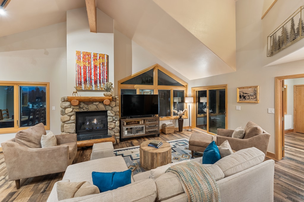 Relax in your spacious living room with soaring ceilings, stone fireplace, and cozy seating perfect for mountain evenings together.
