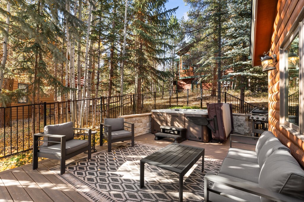 Step onto your private deck surrounded by towering pines and crisp mountain air. Sink into the hot tub after a day of adventure, grill dinner, and gather around the outdoor seating as sunlight filters through the trees.