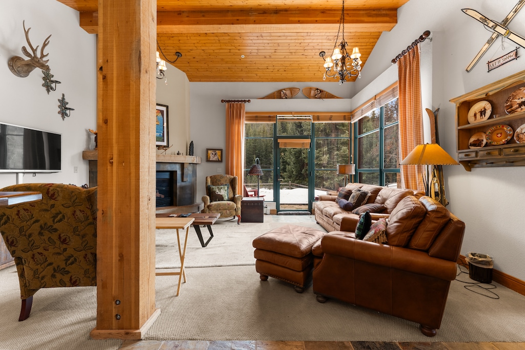 Relax in your mountain retreat with rich leather seating, rustic wood beams, and a cozy fireplace creating the perfect alpine ambiance.