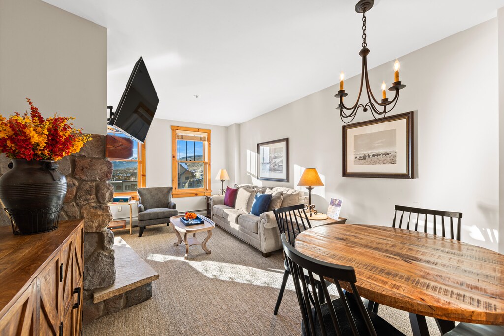 Relax in your spacious living room with cozy fireplace, comfortable seating, and dining table perfect for sharing meals together.