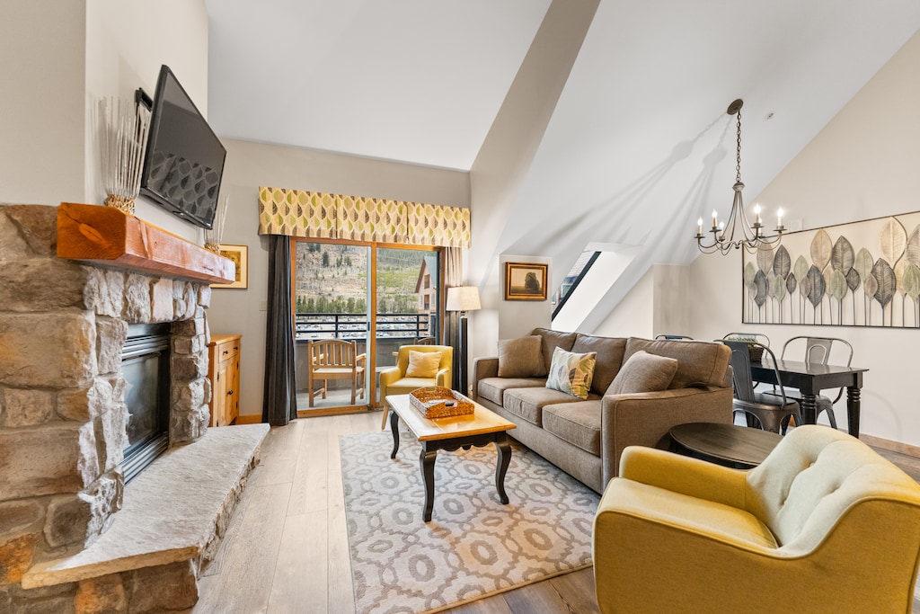Relax in your inviting living space with a crackling fireplace, cozy seating, and mountain views from your private balcony.