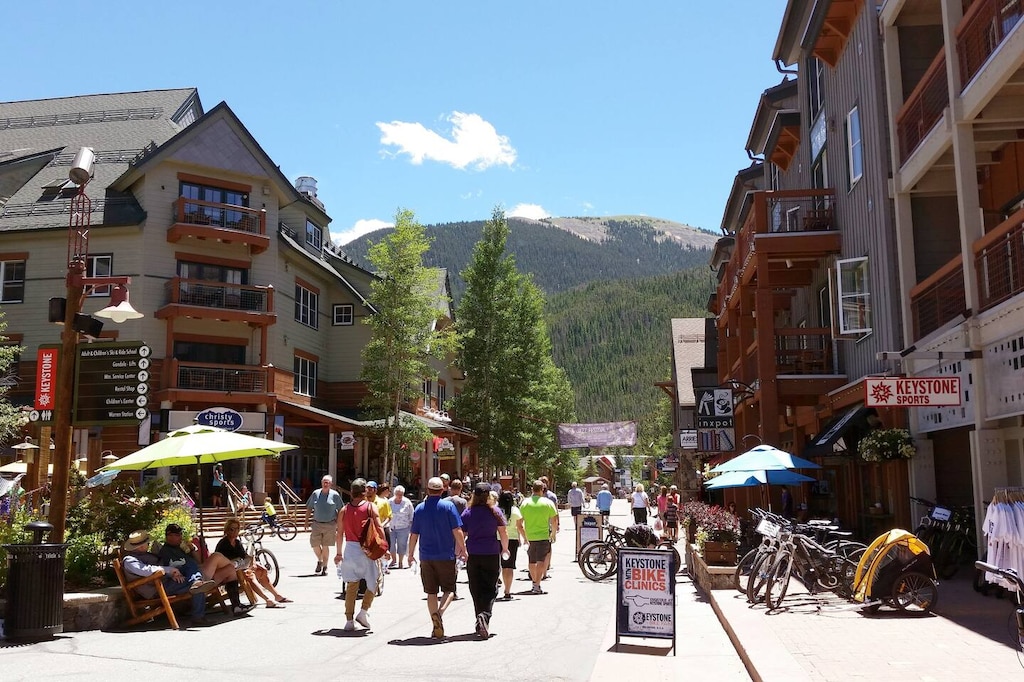 A vibrant mountain village with shops, dining, and outdoor activities awaits just steps from the property, framed by stunning alpine scenery.