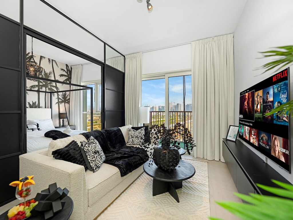 Living room with sliding doors open to 1st Bedroom with king bed.  