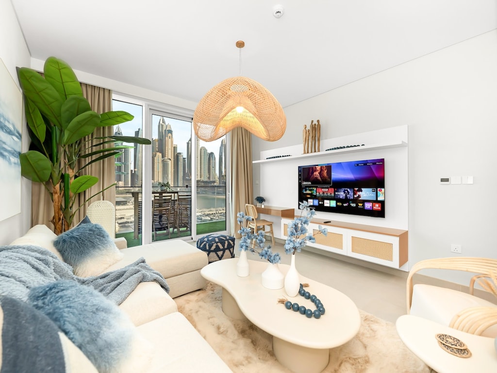 Bright, airy living space with floor-to-ceiling windows showcasing stunning Marina skyline views. 