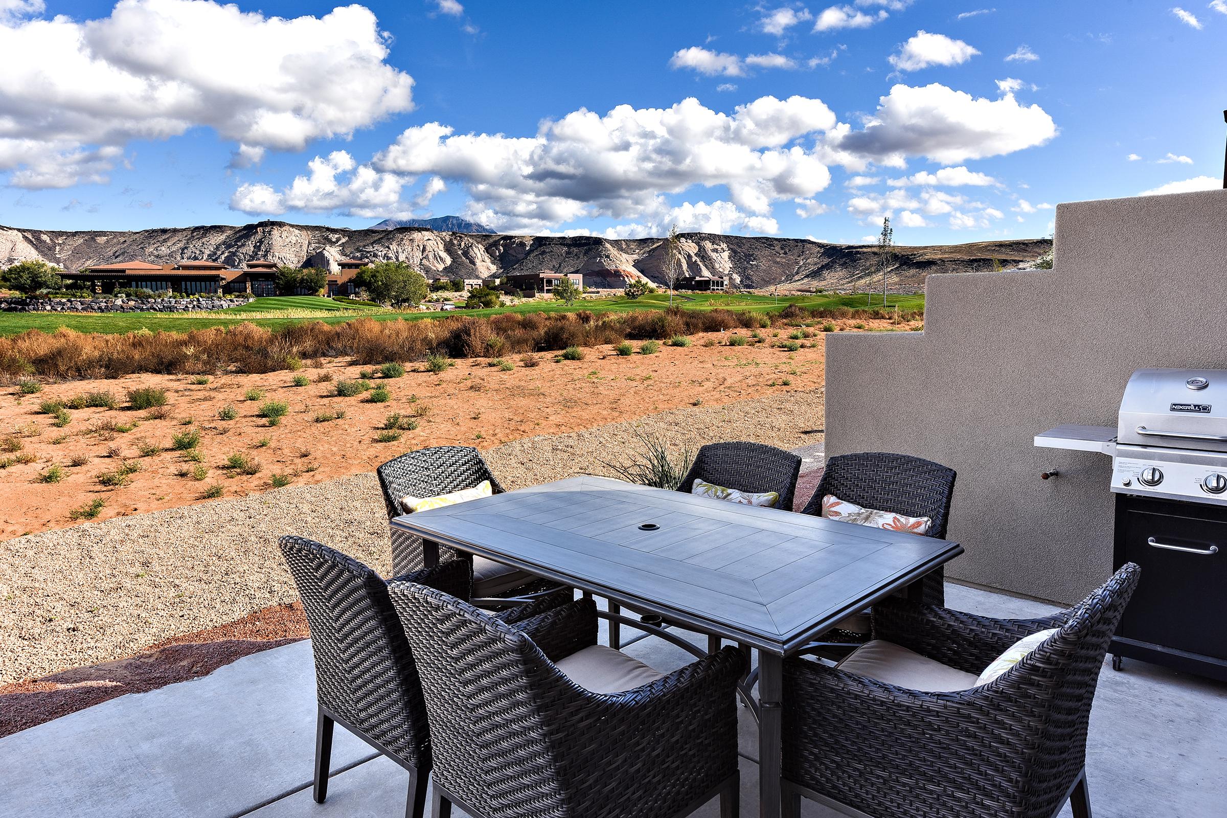 The back patio includes patio furniture for 6 and includes a BBQ grill