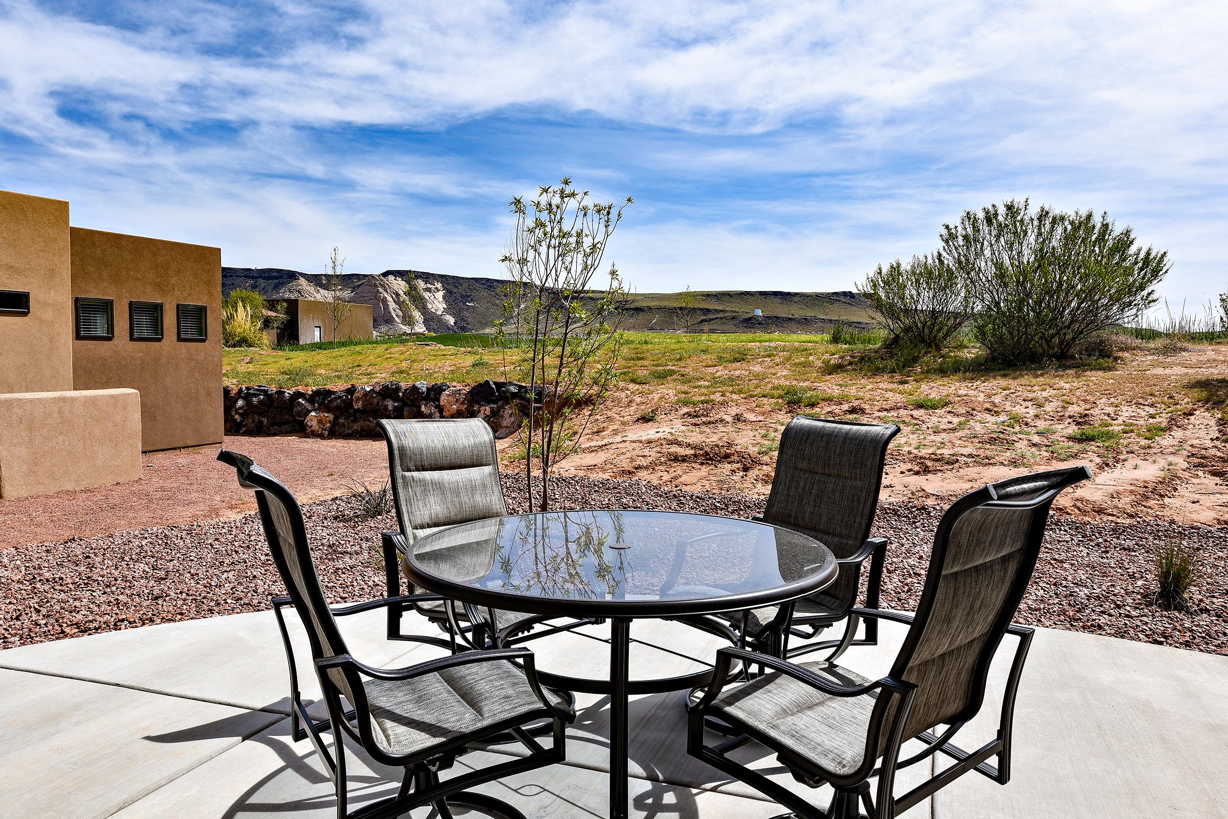 The Back Patio includes a dining table that can comfortably accommodate 4 adults.