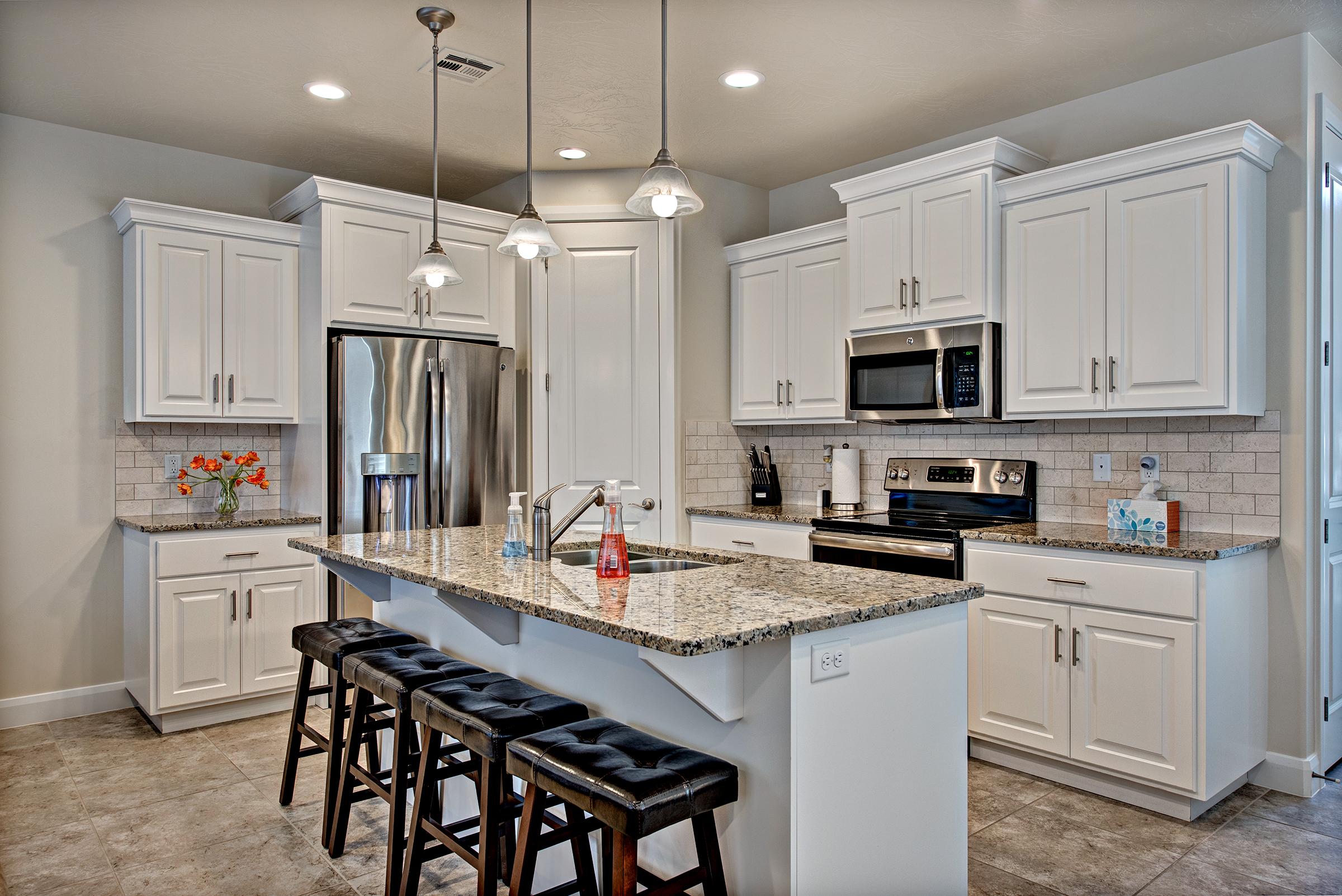 The Kitchen includes stainless steel appliances, granite countertops, walk-in pantry, and plenty of counter space for meal preparations.