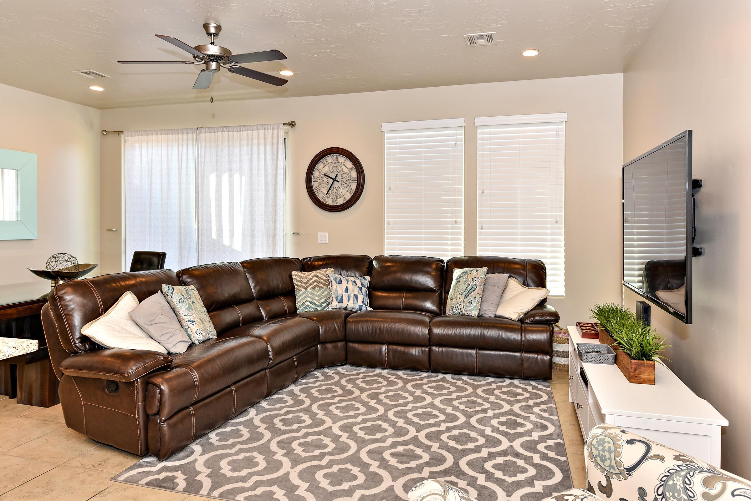 The living room is conveniently adjacent to the kitchen. There is also access to the back patio which has a BBQ grille suitable for all your favorite BBQ dishes.