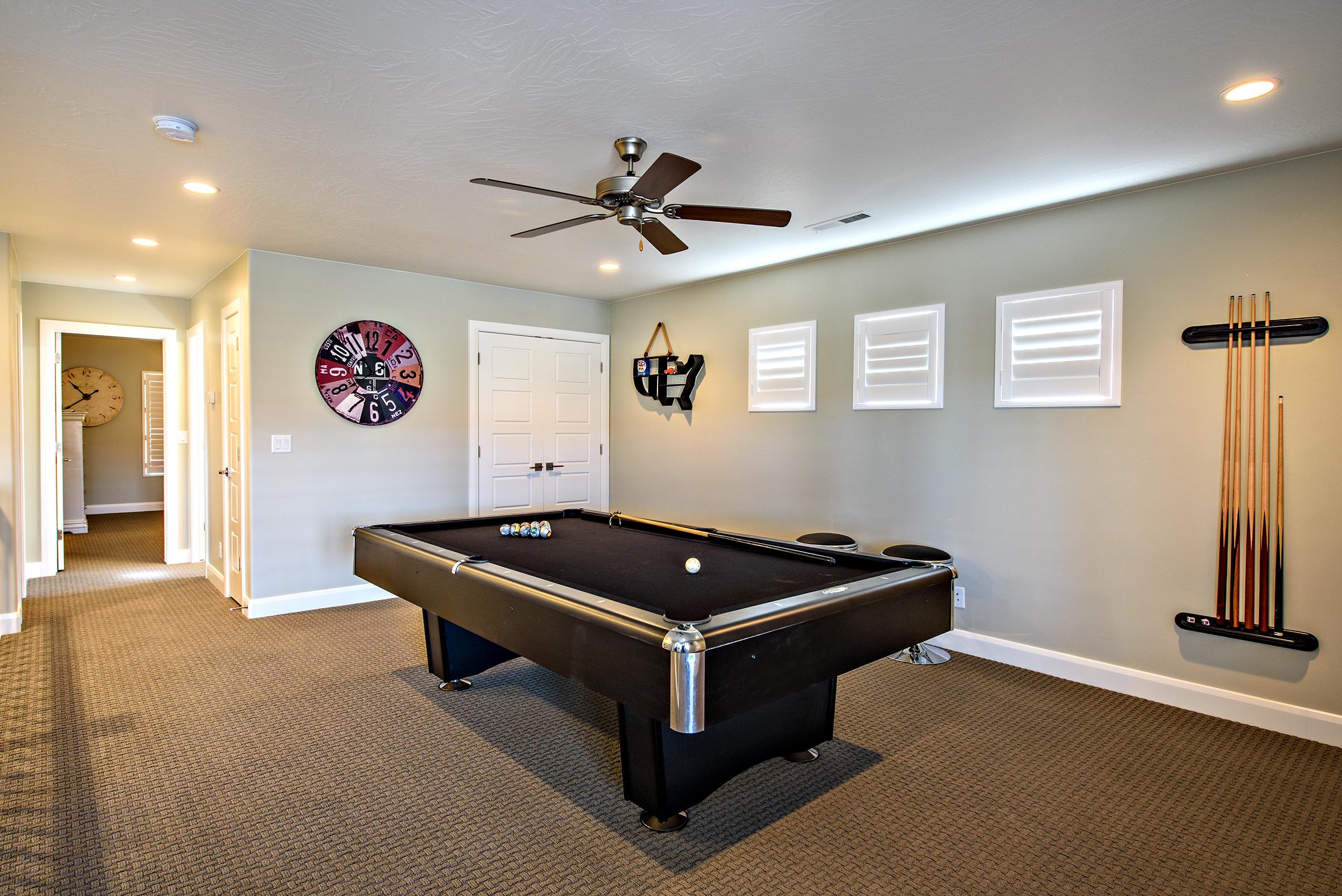 Located upstairs the entertainment room includes a pool table and access to the outside front patio. 