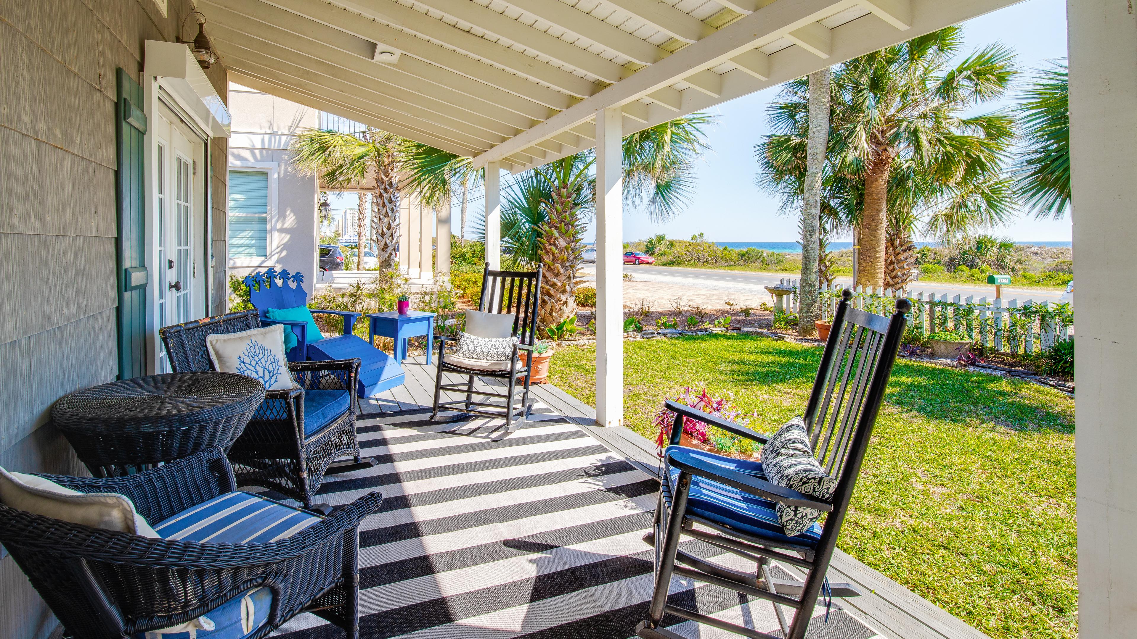 Plenty of seating on the porch for everyone to enjoy morning coffee before a beach day. 