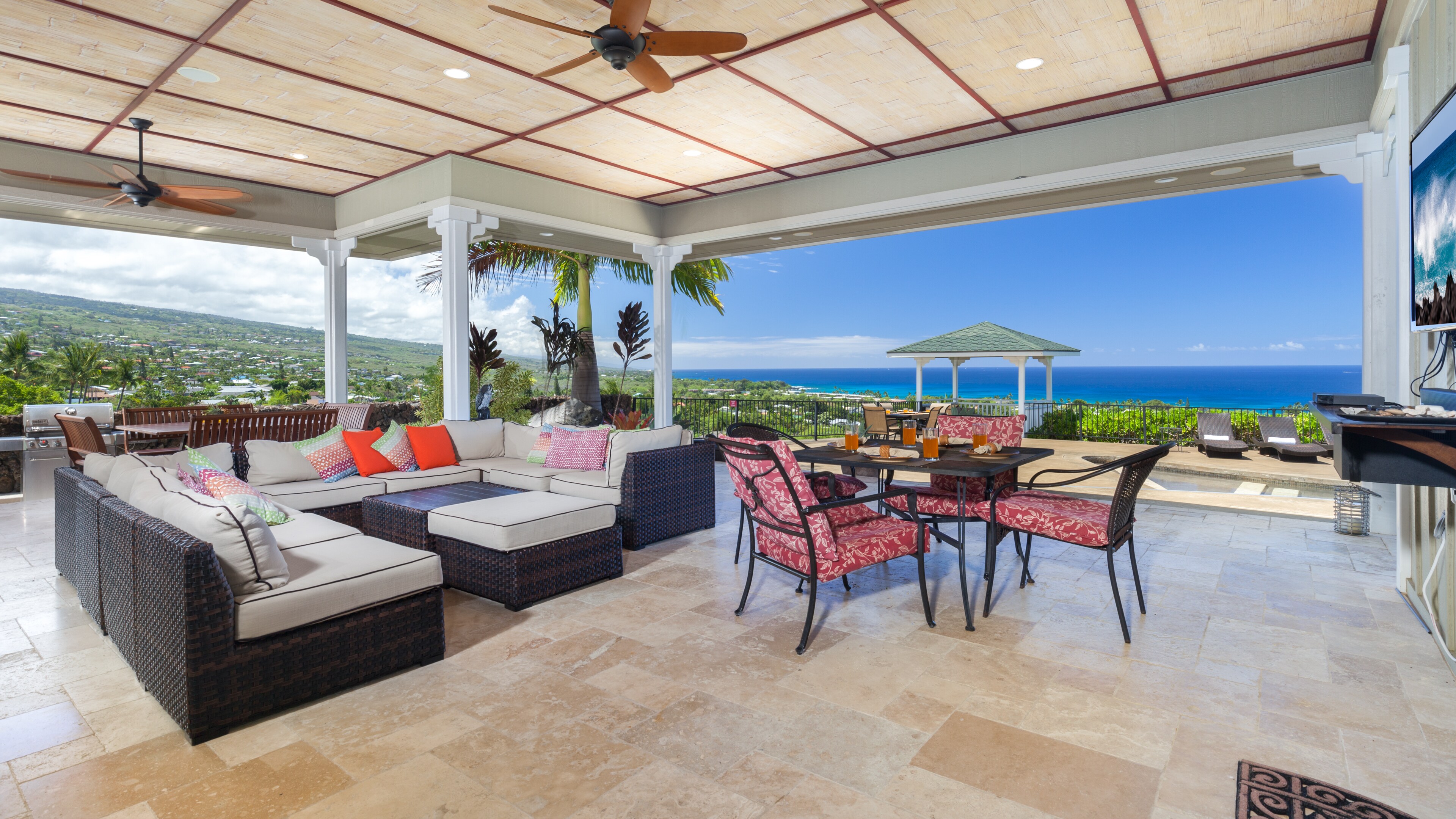 Large Covered Lanai with stunning ocean view and multiple outdoor tables for dining or games night