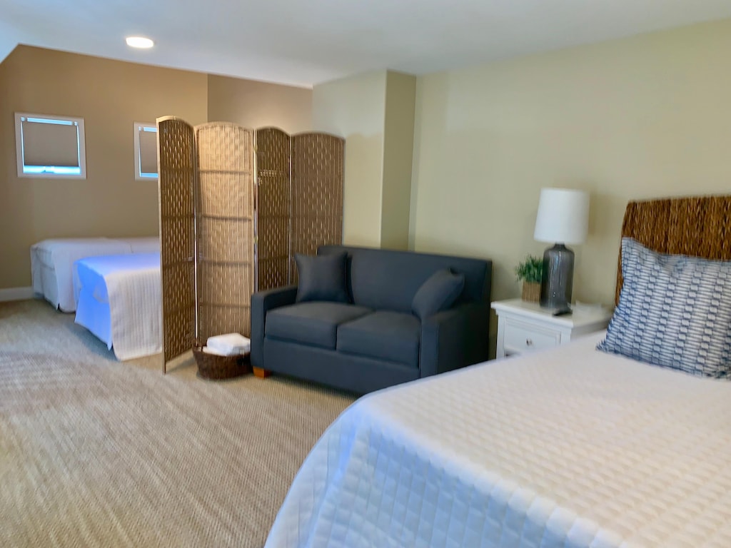 Loft has 2 twins, twin sleeper sofa, and a queen bed. There is a divider for privacy between sleeping areas.
