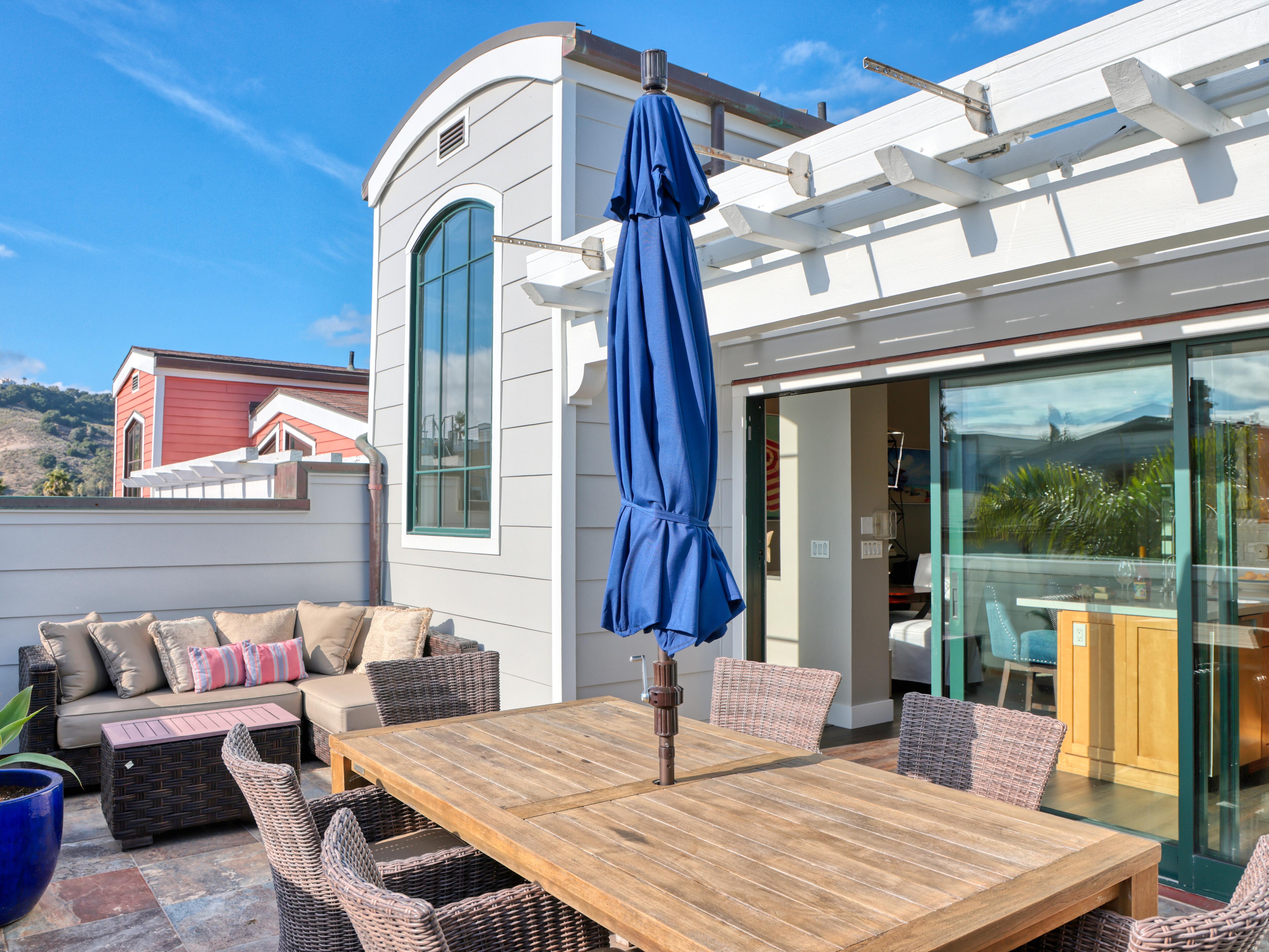 The kitchen's sliding glass doors open to a private patio dining area comfortably seating 6 guests. This shaded space is perfect for enjoying Avila Beach's warm sun.