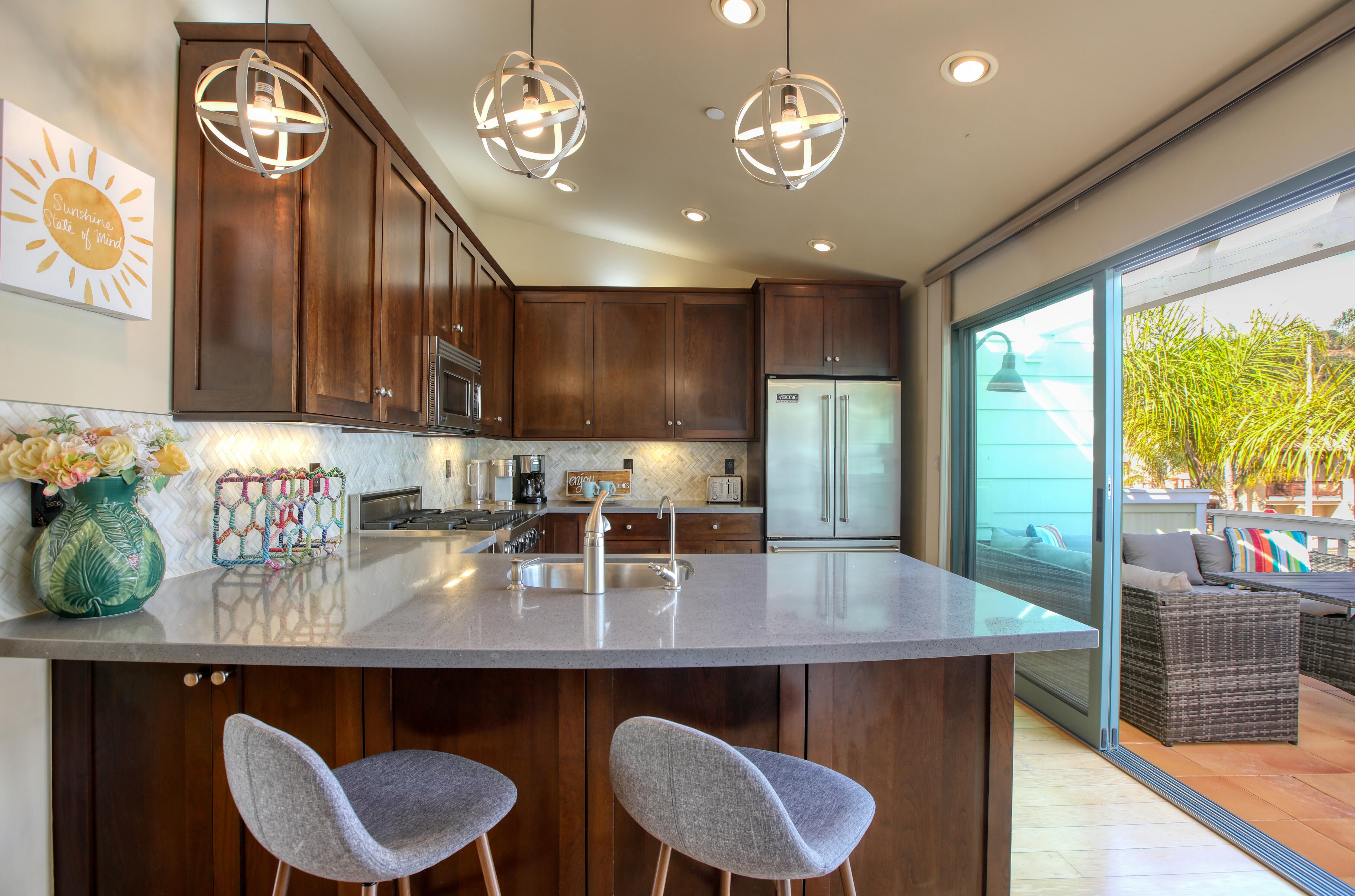 The heart of this beach house is its beautifully designed kitchen, equipped with chef-grade appliances to make cooking a breeze.